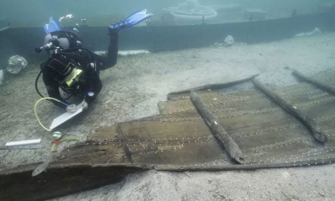 Divers inspecting the Zambratija boat off the Mediterranean coast. Croatia.