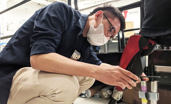 Dr. Tran Minh assembling the bionic leg in the lab.