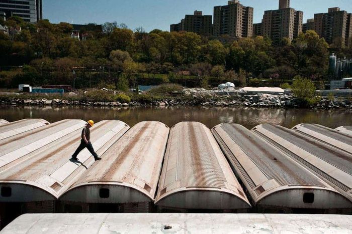 New York subway cars being dumped into the ocean for a good purpose.