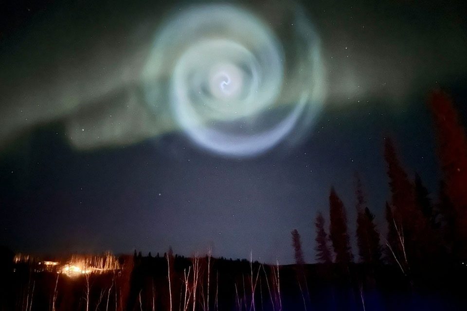 A light blue spiral appeared amidst the aurora for a few minutes in the sky over Alaska.
