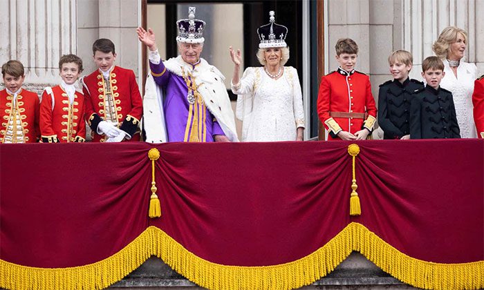 The new king waves to subjects on the balcony of Buckingham Palace