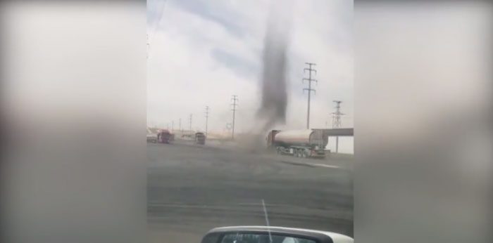 Truck colliding with a tornado.