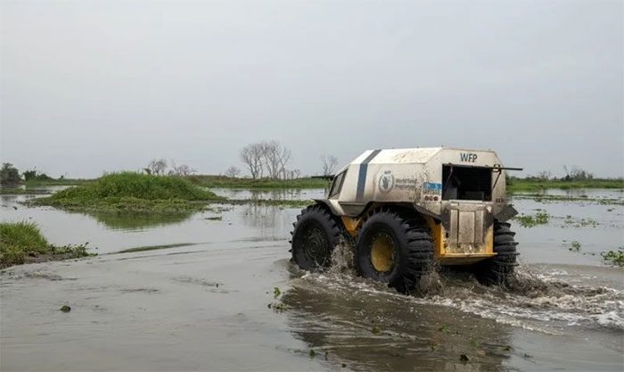 WFP all-terrain vehicle driving through floodwaters in Twic East.