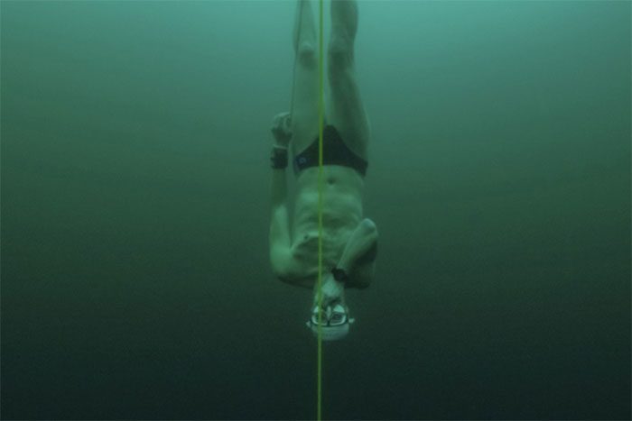 Freediver David Vencl dives 52 meters beneath the ice of Lake Sils on a single breath.