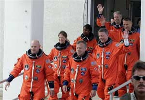 Seven astronauts of the Discovery shuttle wave goodbye before launch