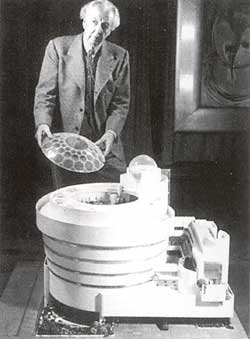 Frank Lloyd Wright with the model of the museum he designed, featuring a glass roof.
