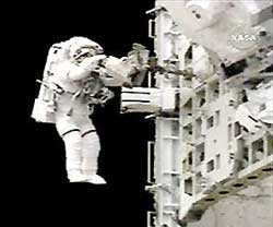 Space Shuttle Discovery astronaut Piers Sellers begins a spacewalk on July 10