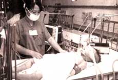 Doctor caring for a patient with Japanese encephalitis