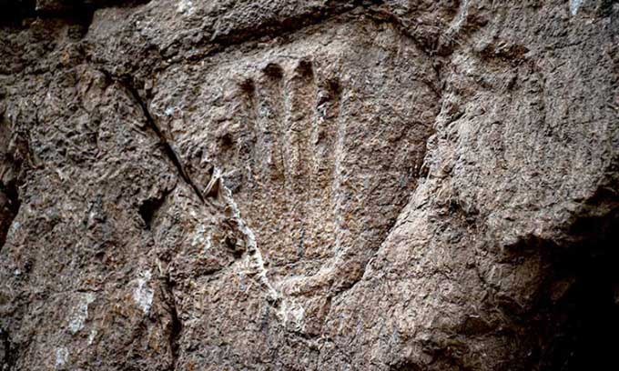 The purpose of the hand carved into the stone wall of the ancient moat remains a mystery.
