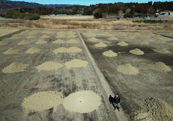Mr. Jinichi Abe at a site to be converted into rice fields.
