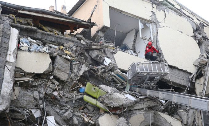 Rescue workers at a collapsed site in Hatay, Turkey, after the earthquake on the morning of February 6.