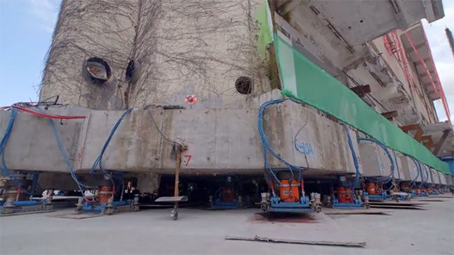 The building moving step by step with the aid of support devices.