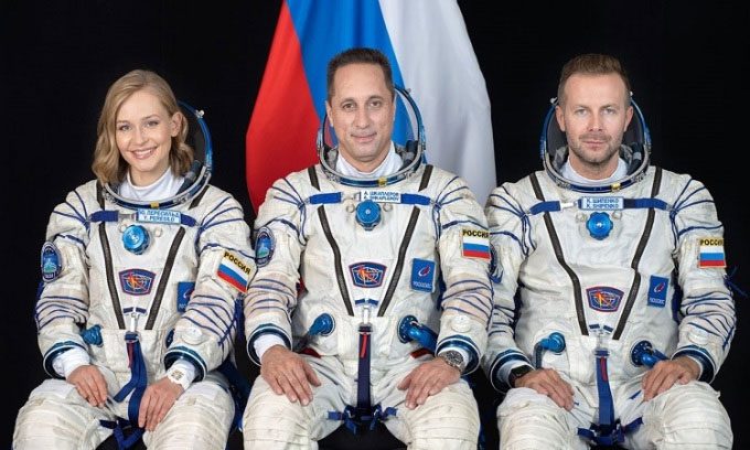 Yulia Peresild, Anton Shkaplerov, and Klim Shipenko in astronaut costumes.