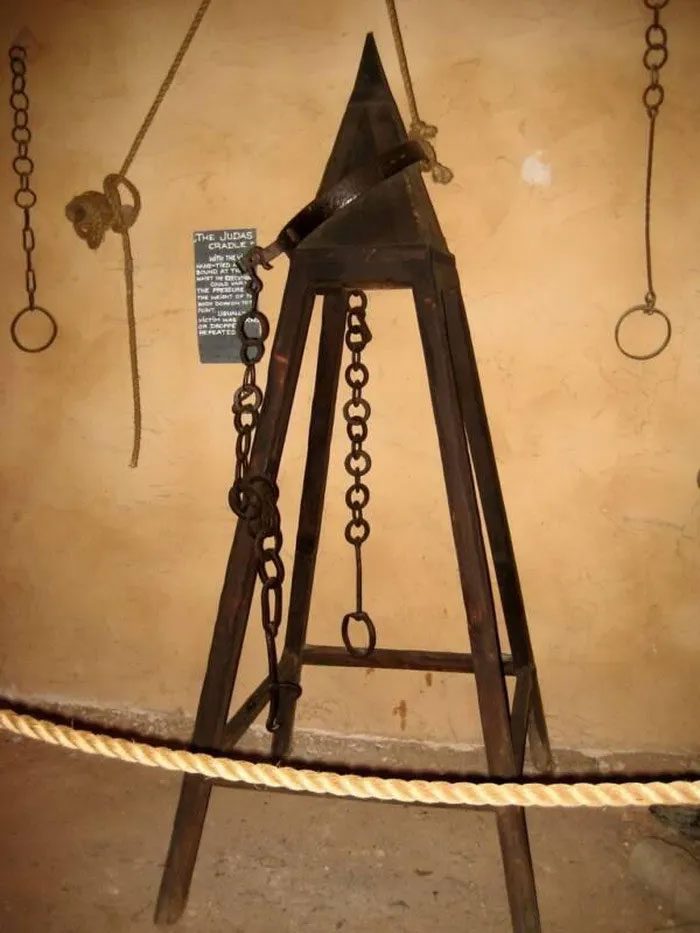 A Judas chair on display in a museum.