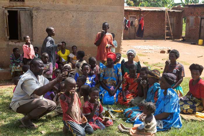 Musa Hasahya (left) with some of his wives, children, and grandchildren outside their home.