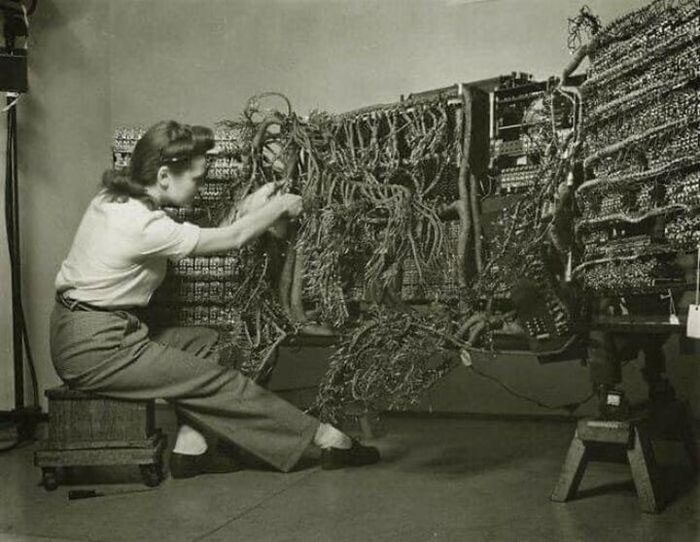 An engineer wiring an early IBM computer in 1958.