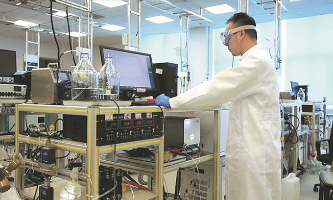 A member of the research team conducting electrolysis experiments