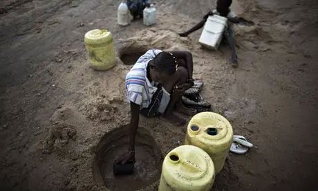 Residents attempting to scoop water from the dry riverbed in Turkana, Kenya.