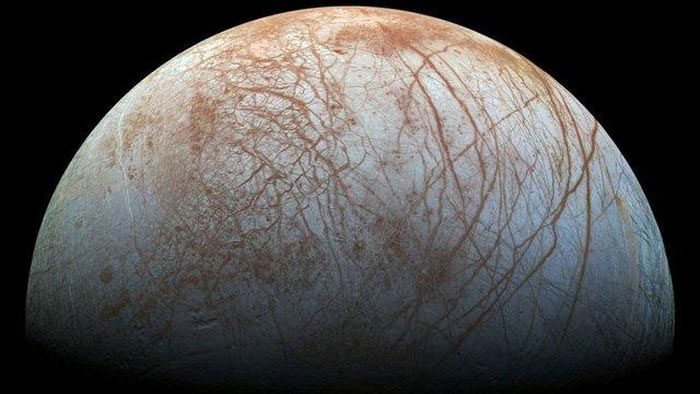 Europa, a moon of Jupiter, contains a subsurface ocean beneath its thick icy crust.