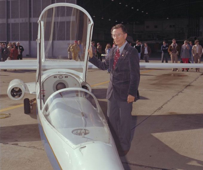 Robert T. Jones stands next to the AD-1 aircraft.