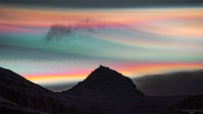 Colorful clouds shining in the night sky above Jökultindur mountain in Iceland