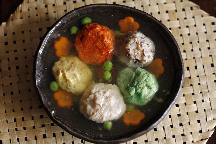 The colorful mọc pieces are steamed separately, then placed in a small bowl and covered with the simmered pork skin broth.