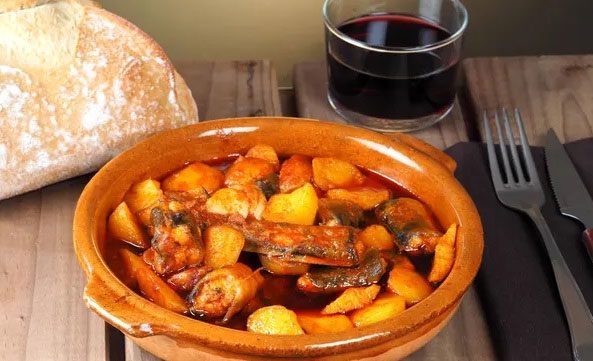 Traditional stew in Valencia featuring European eel, garlic, and paprika.