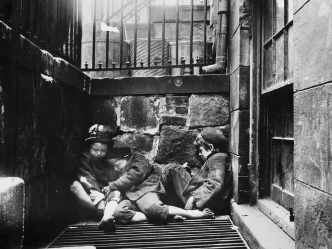 Three boys huddled together for warmth in New York in 1895