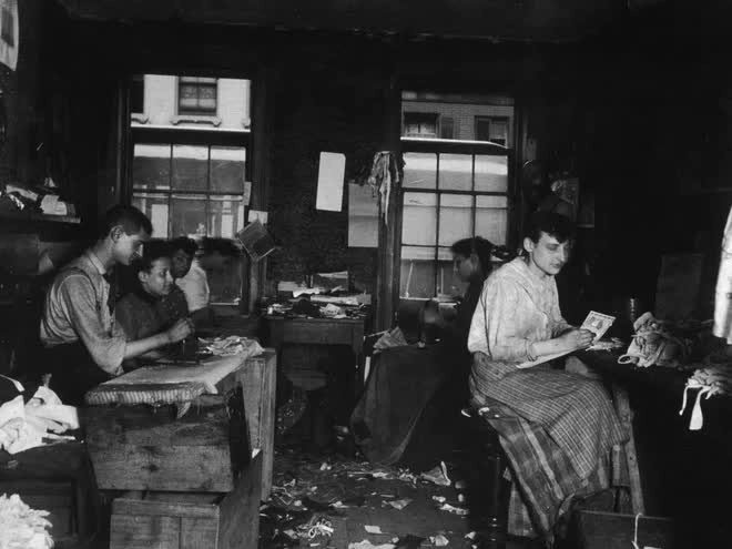 Workers making ties inside an apartment in Little Italy