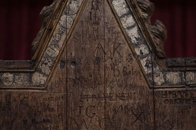 Graffiti on the back of the chair believed to be from the 18th or 19th century.