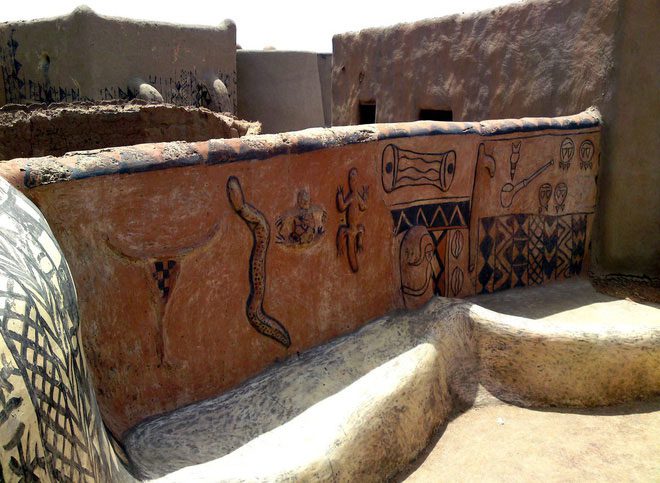 The decoration of these house walls is usually the work of the women in the village.