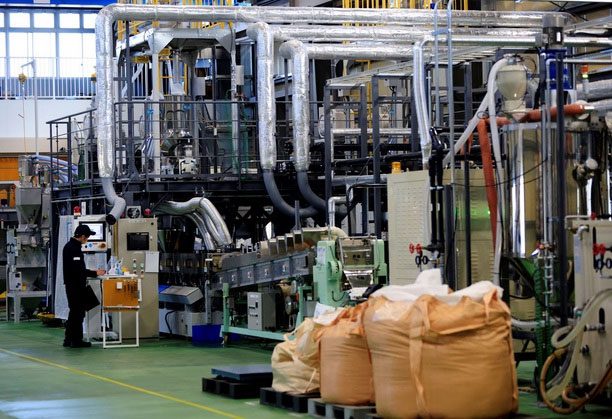Workers at the Biomass Resin factory in Namie.