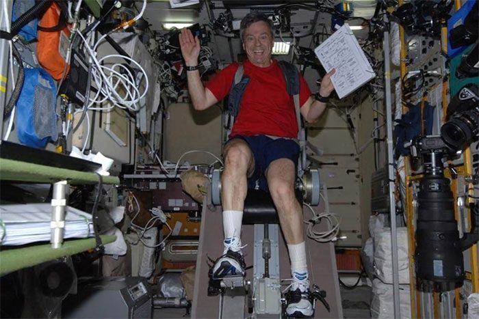 Canadian astronaut Robert Thirsk cycling on the International Space Station.