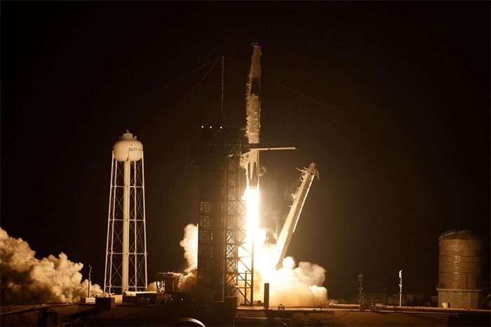 The Falcon 9 rocket carrying the Dragon spacecraft lifts off.