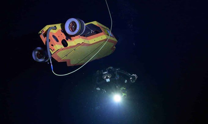 The Sunfish submersible and a diver exploring the Dragon's Breath cave.