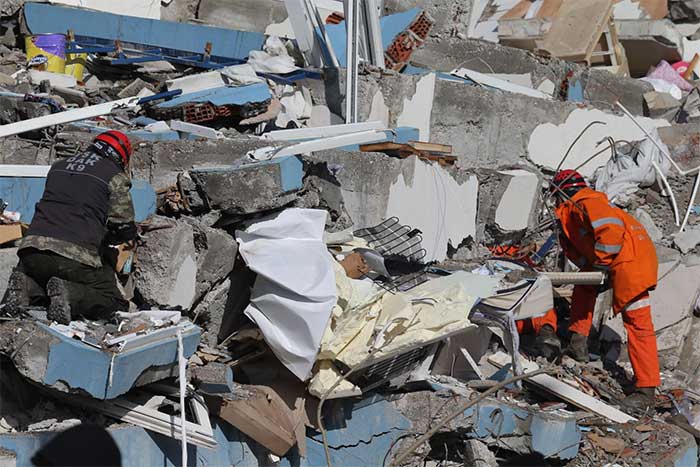 Rescue teams searching for victims at the rubble site after the earthquake