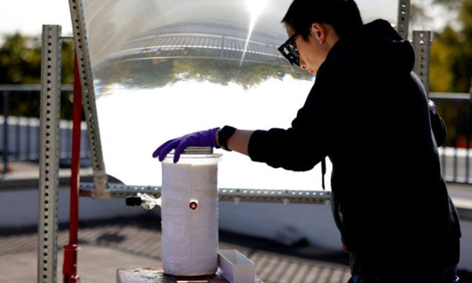 Peng Zhou using a large lens to focus sunlight on the water-splitting catalyst.