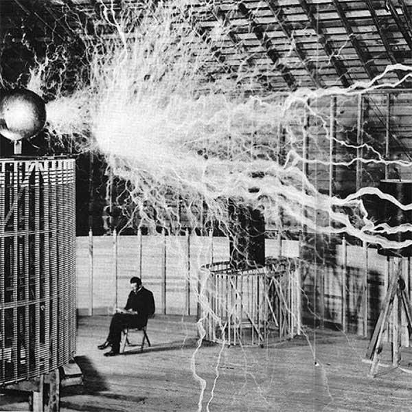 Nikola Tesla sitting in his laboratory with the 'Magnifying Transmitter', December 1899.