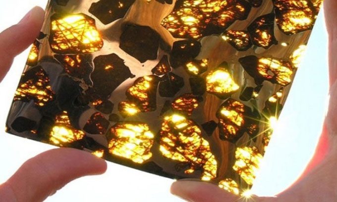 Cross-section of the Pukhang meteorite creating a shimmering golden color effect