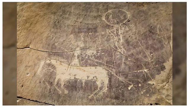 A gray-brown petroglyph depicting a horse and a rider.