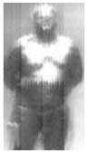 A well-dressed man photographed by a millimeter wave camera. Note the gun cleverly concealed. The T-ray camera is said to be similar but stronger.
