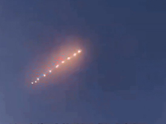 Unidentified glowing spheres flying in one direction