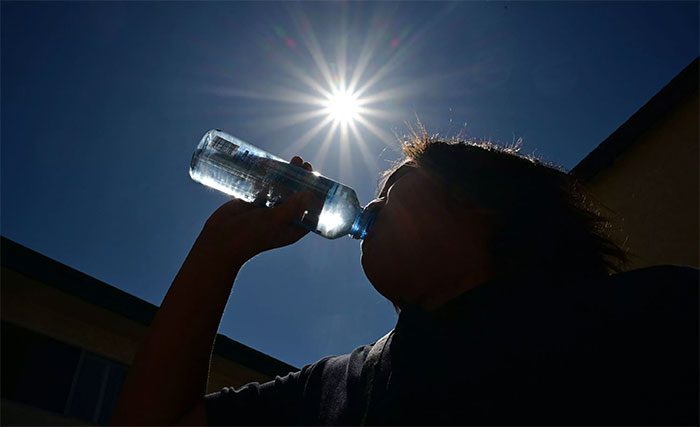 Children drinking cooling water in Los Angeles, California, USA, on August 30, 2022.