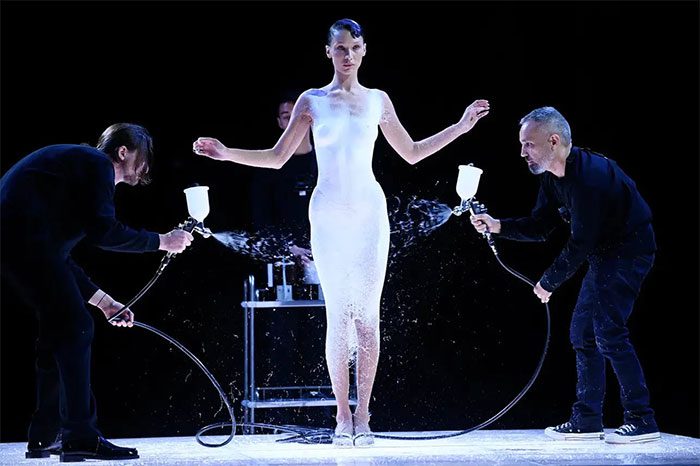 Model Bella Hadid and the custom-made outfit created on-site using a liquid.