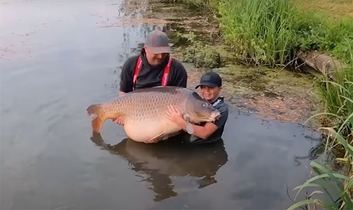 Callum Pettit and his father Stuart with the 43.5 kg carp.