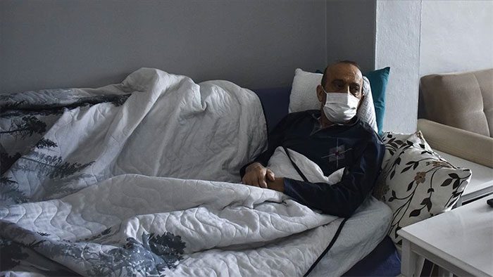 Mr. Muzaffer Kayasan in bed, self-isolating at home for 14 months