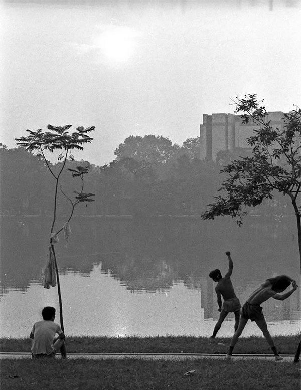 Sunrise over Hoan Kiem Lake. Across the lake is the Hanoi People's Committee building.