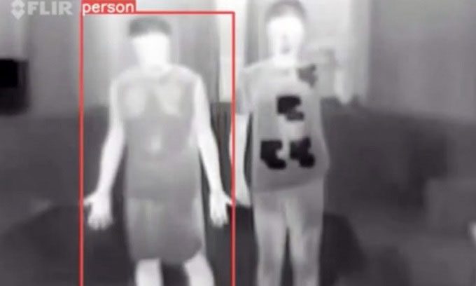 The InvisDefense cloak prevents security cameras from detecting a person passing by.
