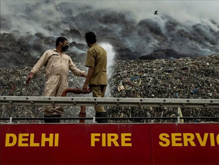 Firefighters from the Delhi Fire Service (DFS) extinguishing the fire.