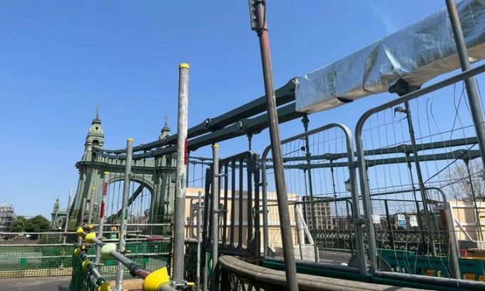 A section of Hammersmith Bridge wrapped in foil.